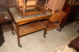 A light oak two tier drop flap trolley and another trolley.