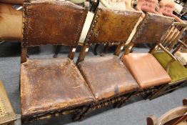 Three leather upholstered dining chairs.