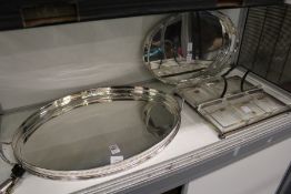 Two good plated galleried twin handled oval trays and an hors d'oeuvres dish with glass liners.