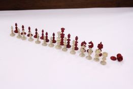 Miniature chess pieces housed in a box made from a walnut.