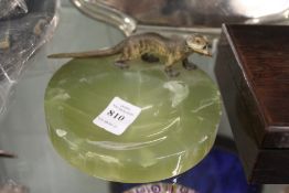 An onyx and cold painted bronze ashtray mounted with an otter holding a salmon in its mouth, 4.75ins