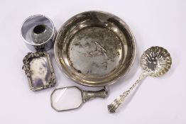A small silver handled magnifying glass and other items.