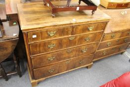 An 18th century walnut chest of two short and three graduated long drawers (top stripped and re-