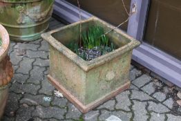 A large square shaped terracotta garden planter.