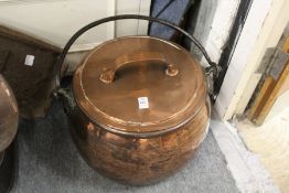 A good large copper cooking pot with wrought iron handle (associated lid).