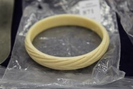 An early 20th century carved ivory bangle.