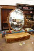A mahogany bow fronted dressing table mirror.