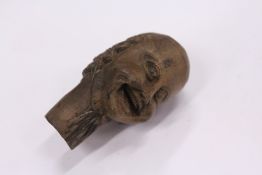 A small carved wood okimono of a head.