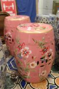 An unusual pair of Chinese barrel seats, pink ground with floral decoration.