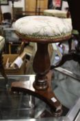 A 19th century mahogany revolving piano stool.