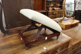 A mahogany framed adjustable foot stool, stamped T. May.