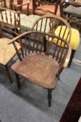 A 19th century ash elm and yew low Windsor armchair.