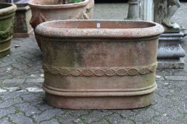 A good large oval terracotta planter with moulded decoration, stamped with a manufacturer's name.