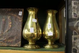 A pair of heavy brass baluster shaped vases.