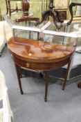 A mahogany D-shaped foldover card table with a single drawer on tapering square legs.