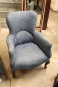 A small blue upholstered armchair.