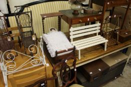 A wrought iron cradle, a mahogany half tester doll's bed frame, a garden bench seat and a swing