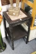 A Chinese carved hardwood two tier marble top stand.