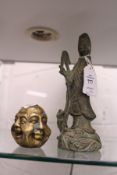 A Chinese bronze figure of Guanyin together with a small brass four faced Buddha.