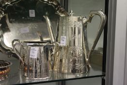 A plated coffee pot in Chinese style together with a similar milk jug and sugar bowl.
