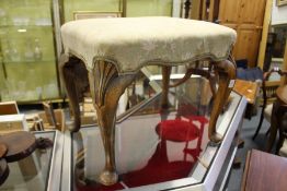 A Georgian style walnut and upholstered stool.