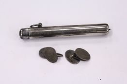 A pair of silver cufflinks and propelling pencil.