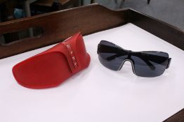 A cased pair of Prada sunglasses.