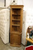 A pine standing corner display cabinet.
