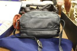 A ladies' black leather handbag with an outer travelling case.