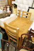 A good modern light oak rectangular dining table with six ladder back chairs.