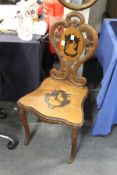 A Black Forest carved and inlaid walnut hall chair.