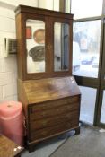 A good George III mahogany bureau bookcase, the upper section with a pair of mirrored doors.