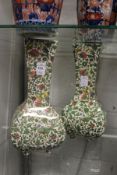 A pair of Royal Doulton Persian ware vases.
