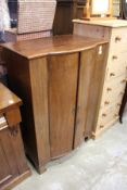 A mahogany bow fronted two door cabinet.