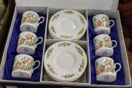 A set of six Aynsley Cottage Garden coffee cans and saucers, boxed.