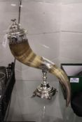 A bovine horn cornucopia vase with plated mounts and cover.