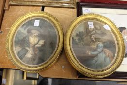 A pair of gilt framed oval coloured engravings of ladies.