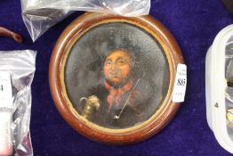A small circular portrait of a man with a pipe and flagon of foaming ale (lid of a papier mache