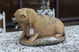 A composite garden ornament modelled as a pig.
