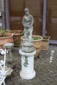 A composite garden classical figure mounted on a fluted pedestal column.