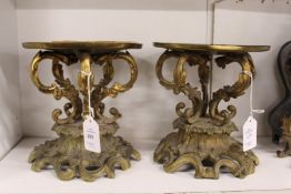 A pair of French ormolu rococo style stands.