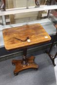 A 19th century rosewood rectangular occasional table on turned column support with platform base.