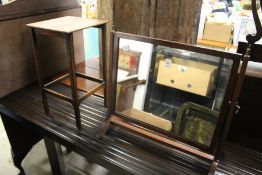 A dressing table mirror and a small oak table.