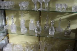 A good collection of cut glass decanters.