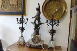 A late 19th century French clock garniture with figural mount.