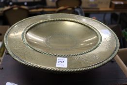 An engraved brass pedestal dish.