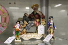 A Capodimonte figure of a tramp on a bench and two small continental figurines.
