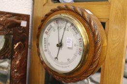 A Victorian oak framed aneroid barometer.