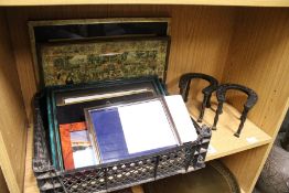 Photograph frames and a pair of horseshoe shaped metal stands.