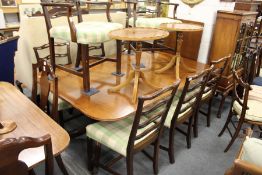 A good George III design mahogany twin pillar extending dining table with one leaf.